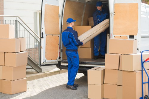 Removal team preparing a safe move with protected furniture