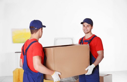 Removal crew preparing household items for transport under service terms