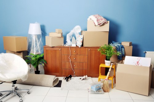 Professional movers carrying furniture during a Wimbledon house move