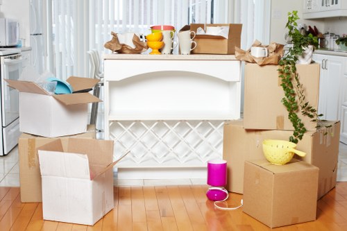 Workers lifting and carrying furniture using proper manual handling techniques