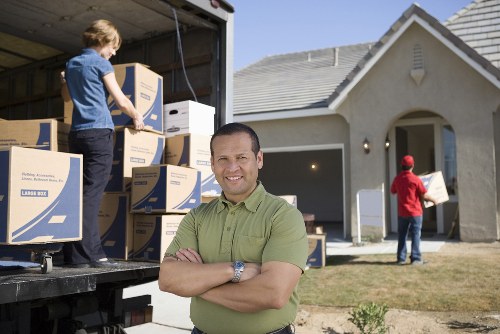 Professional flat removals planning in Wimbledon with moving boxes and a removals van