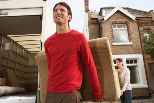 Movers navigating stair access and tight spaces during a Wimbledon flat move