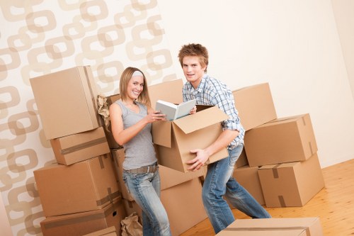 Movers carrying boxed belongings during a short notice removal in Wimbledon