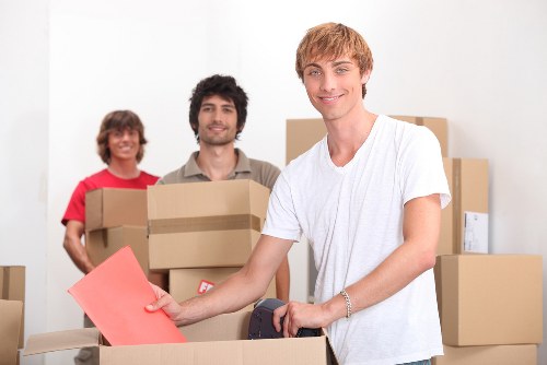 Local movers handling furniture in a Wimbledon property