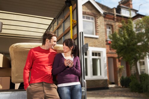 Moving crew wearing PPE while carrying household items safely