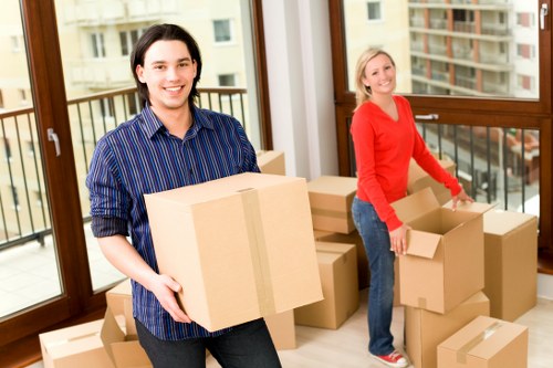 Packed moving boxes and protected furniture ready for a Wimbledon home move